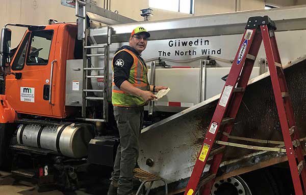 MnDOT employee Mike Conner with snowplow truck that is named Giiwedin which means North Wind