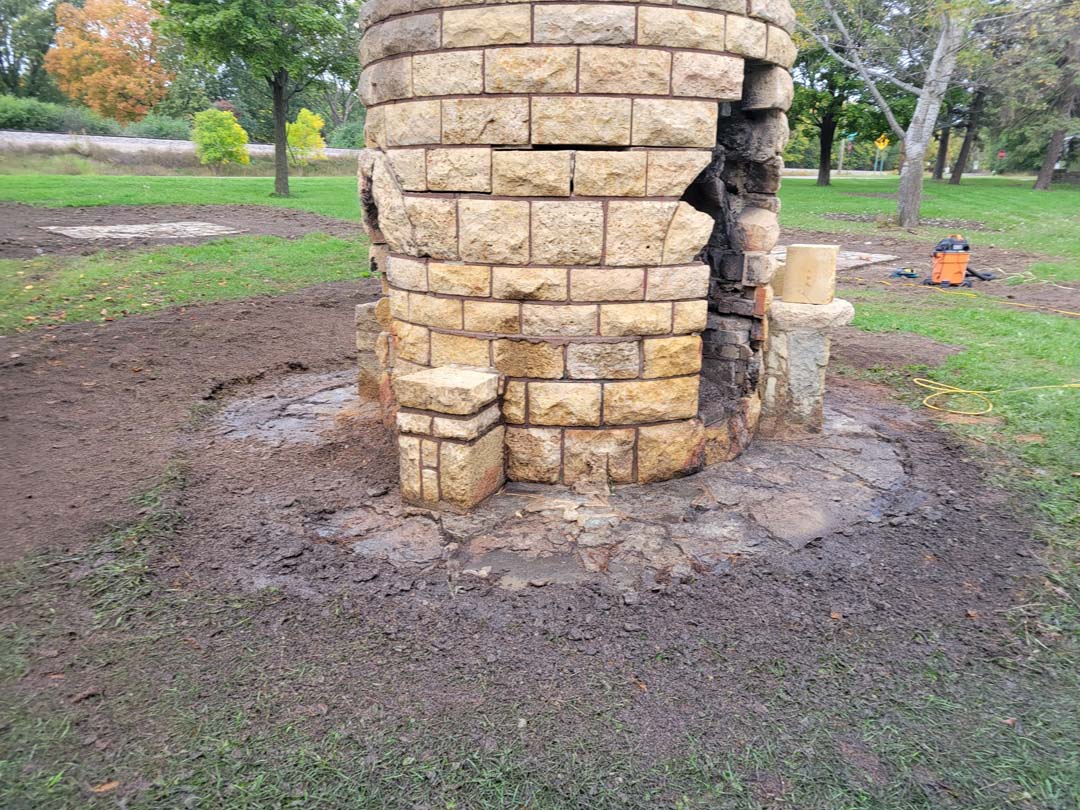 picnic area cylindrical stone fireplace, called a “beehive” with newly exposed stone ring around base